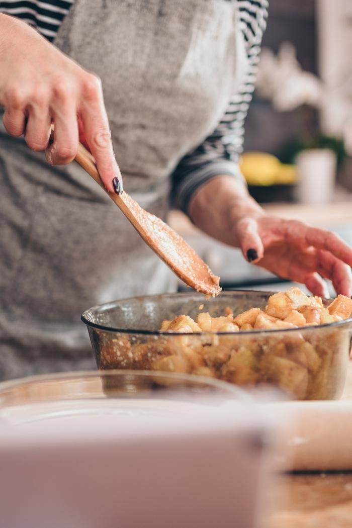 woman stirring apple pie ingredients