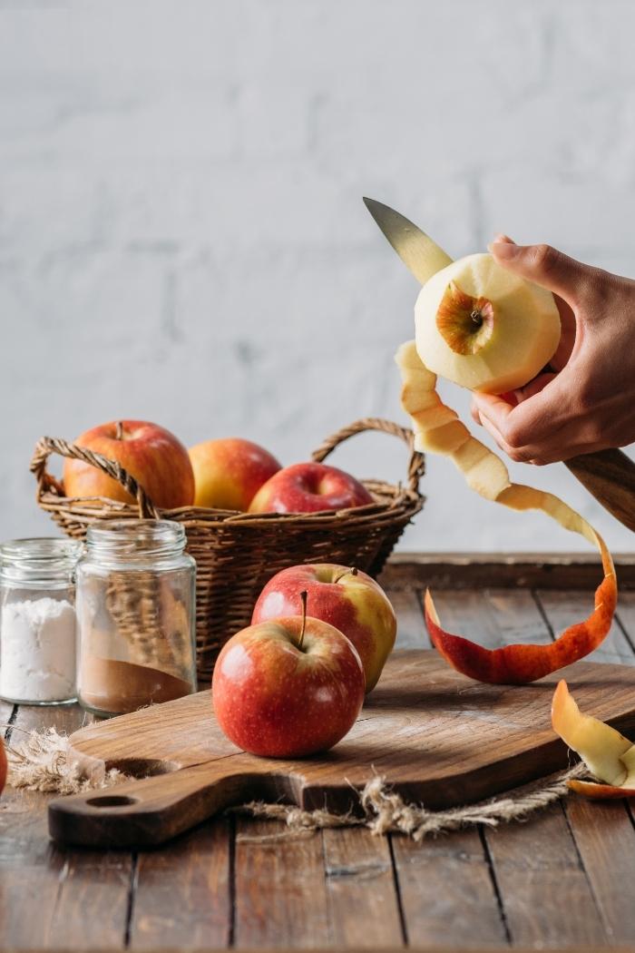 woman peeling apples to make an apple crisp with oatmeal