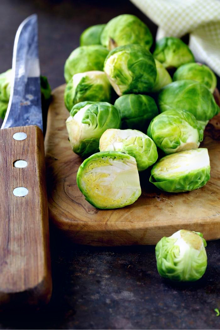 brussels sprouts on a cutting board with knife