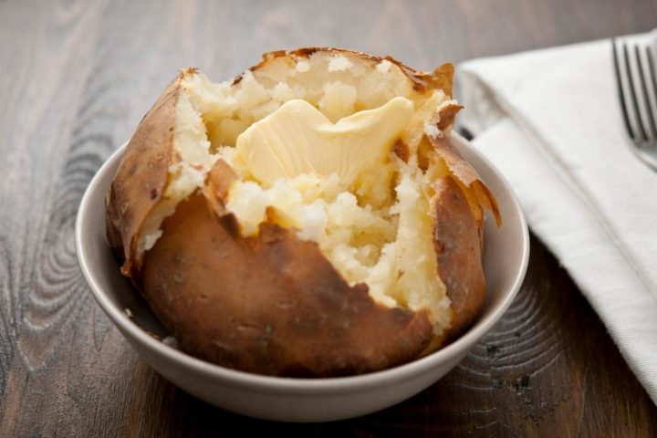 baked potato in a bowl with butter melting