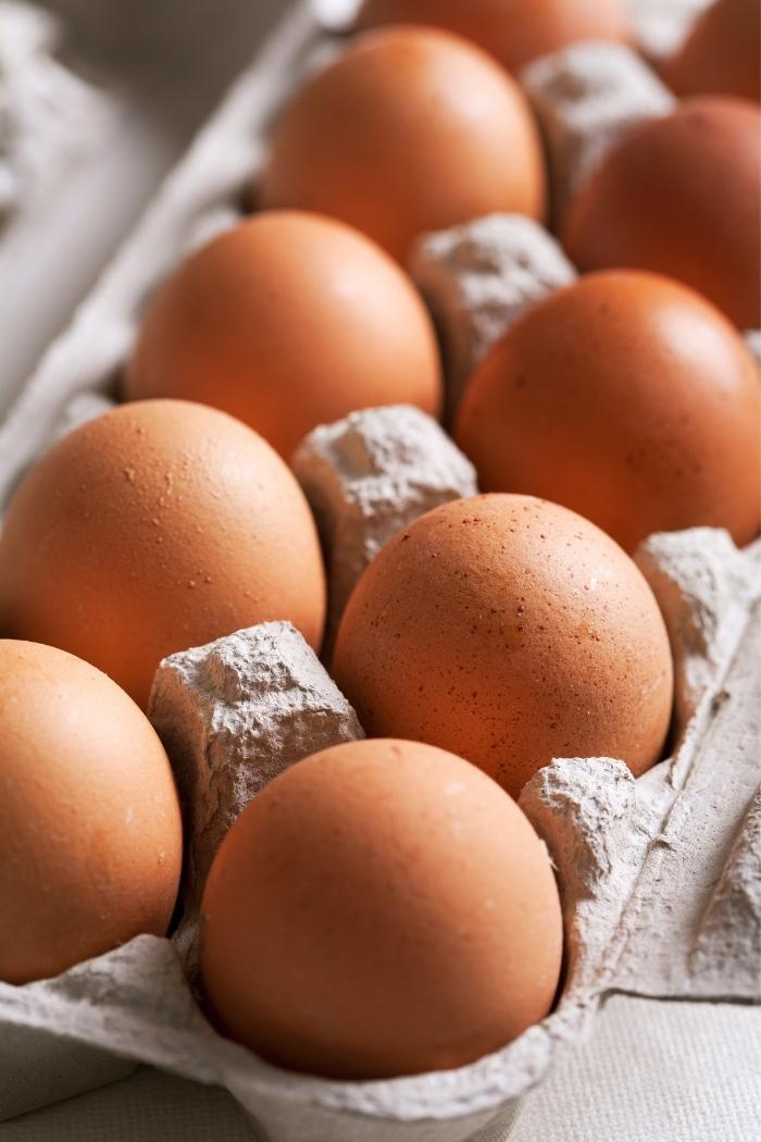 close up photo of brown eggs in a carton for instructions about how to freeze eggs
