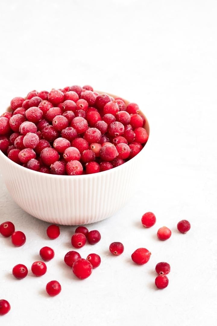 frozen cranberries in a white bowl