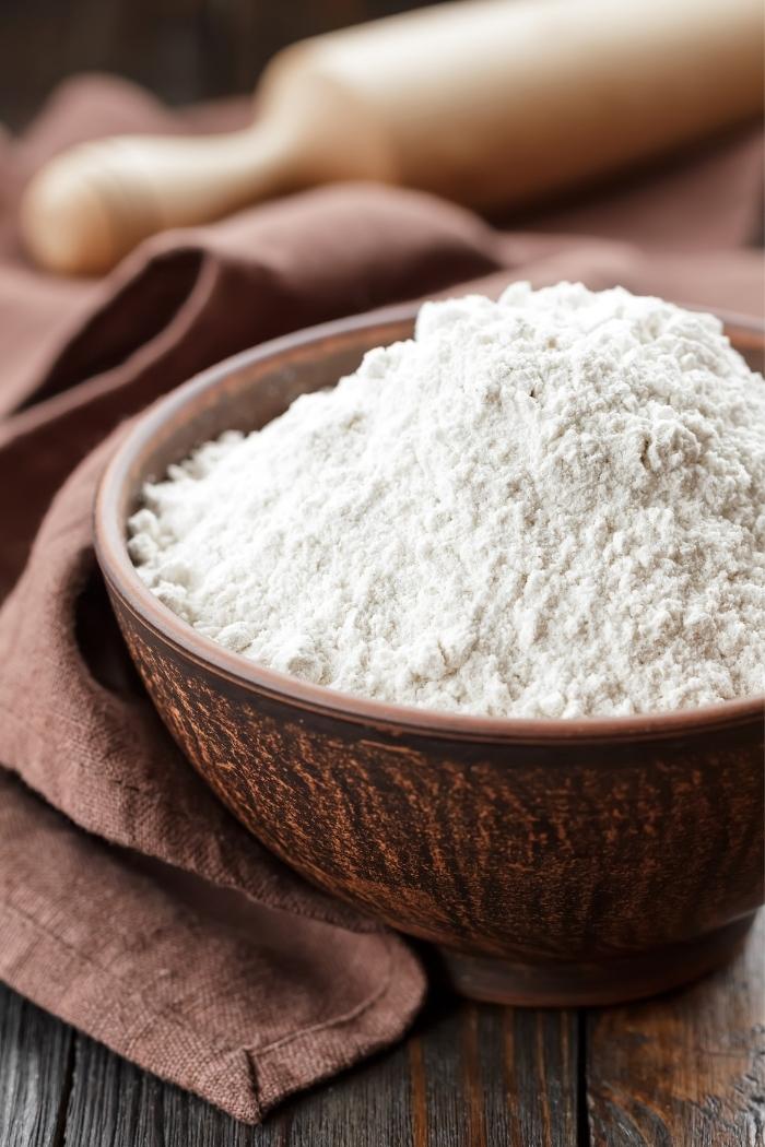 bowl of flour on rustic background