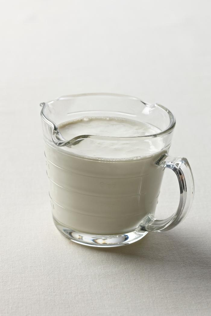 glass measuring cup of cream