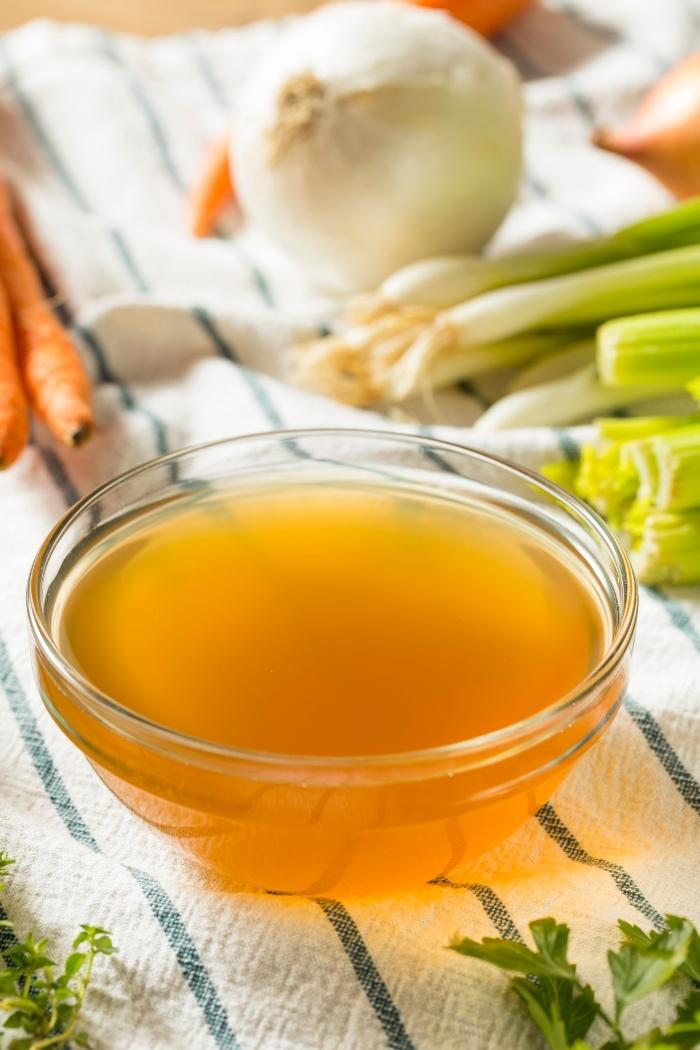 clear glass bowl of vegetable broth