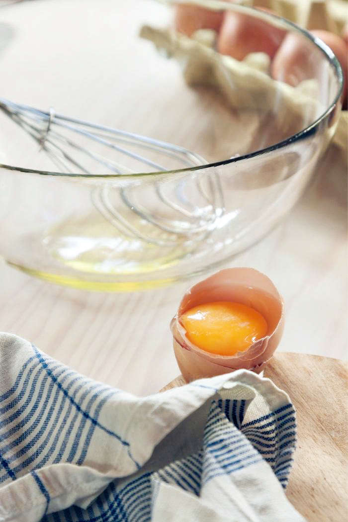 egg whites in a bowl with cracked egg shell and yolk