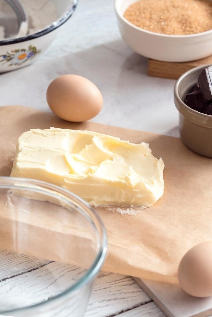 soft butter on a kitchen counter with baking ingredients