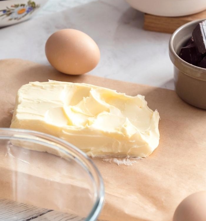 soft butter on a kitchen counter with baking ingredients