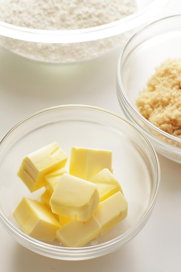 a clear bowl of cubed butter on a counter