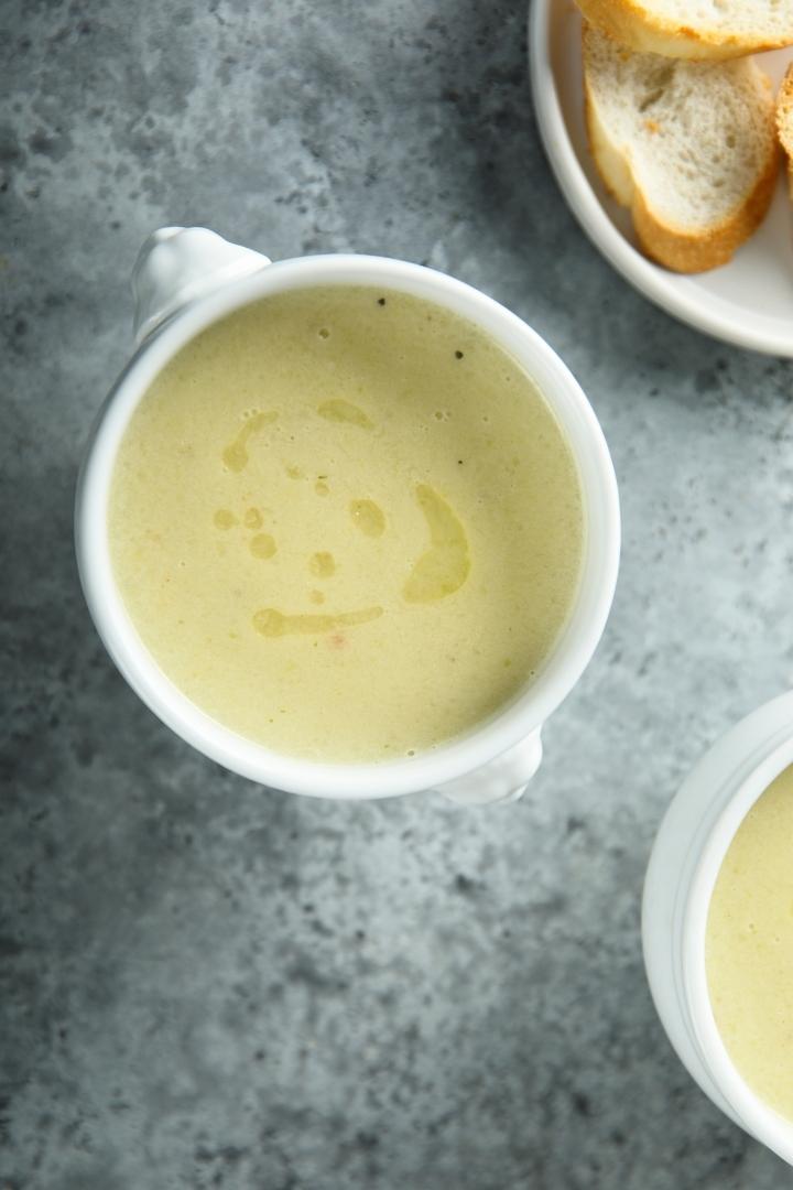 overhead shot of white bowl of potato leek soup