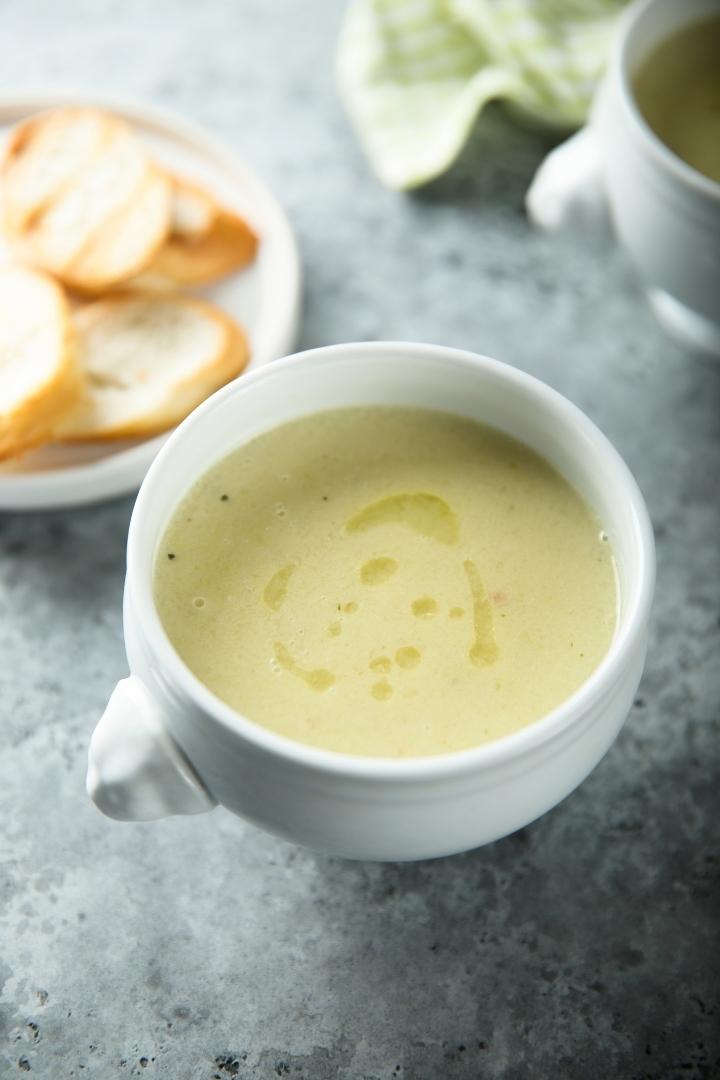 white bowl of potato leek soup