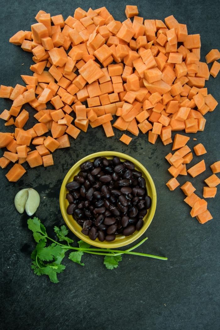 sweet potato cubes and black beans on a dark surface
