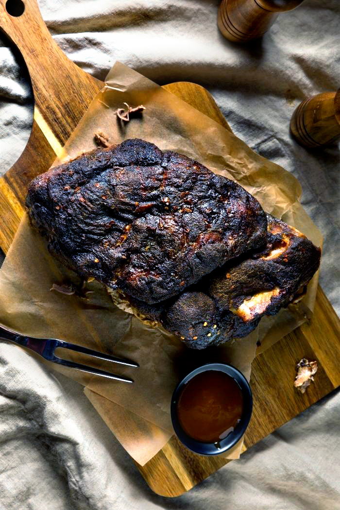 a photo of a trager smoked pulled pork on a cutting board