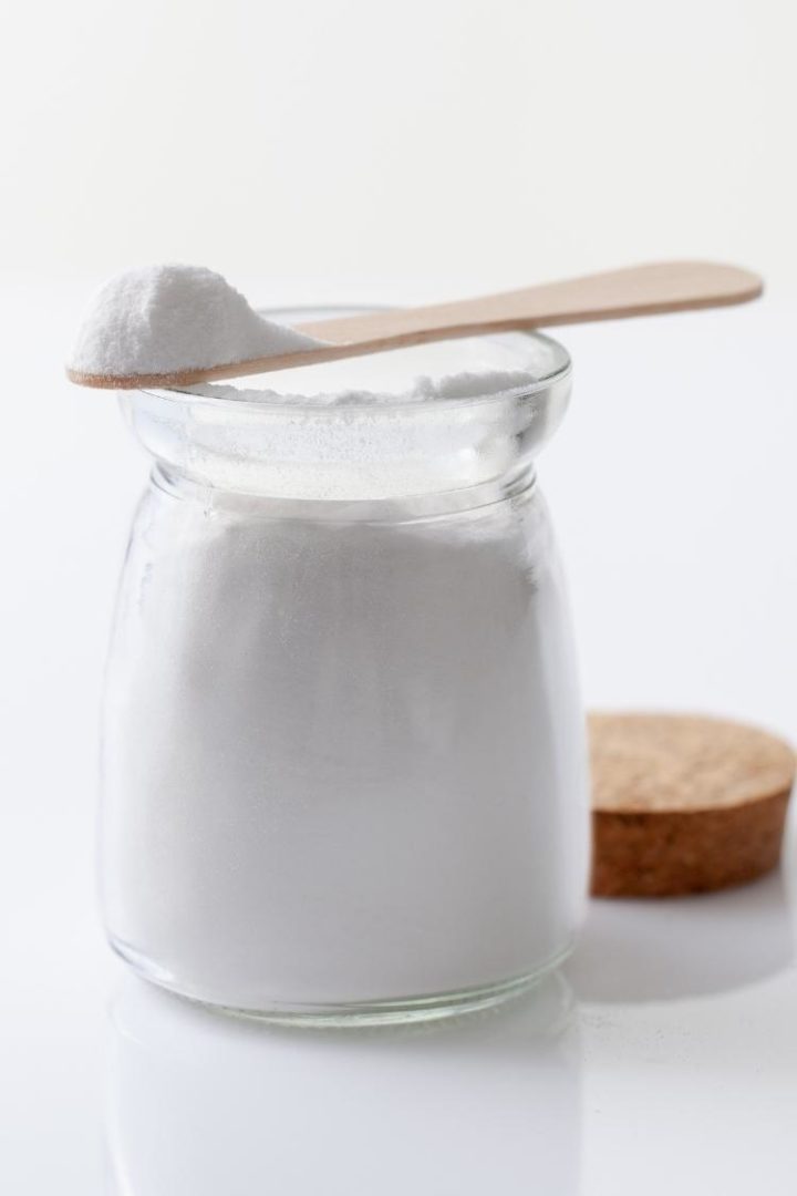 jar of baking powder with wooden spoon