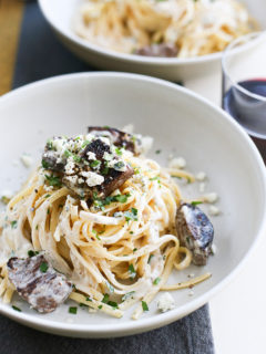 overhead image of gorgonzola pasta with beef in a white bowl