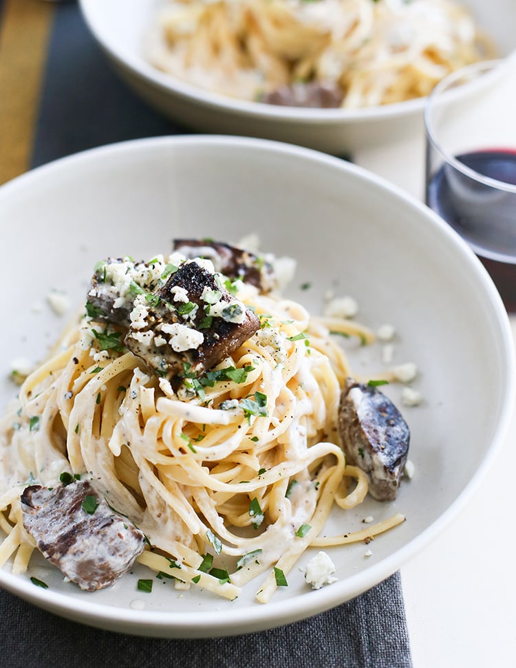 overhead image of gorgonzola pasta with beef in a white bowl