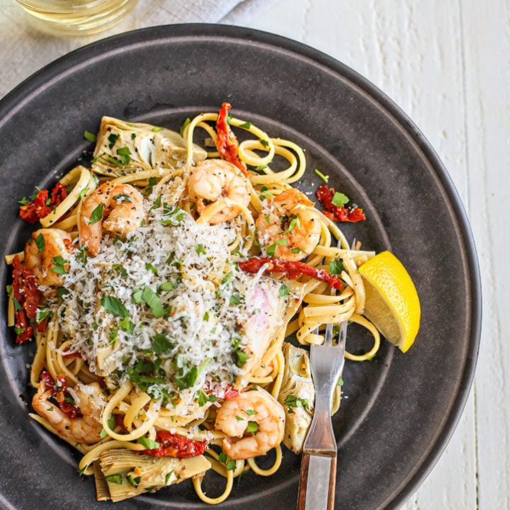 a plate of shrimp scampi with garlic butter sauce