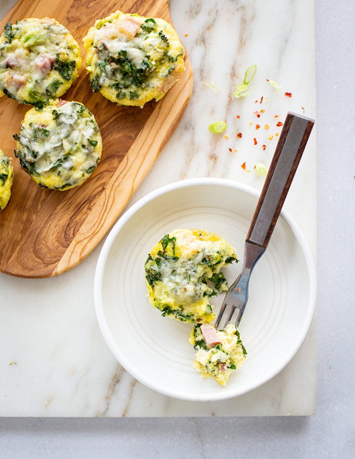 overhead shot of a mini Crustless Broccoli Quiche on a plate with fork