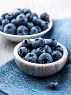 bowl of fresh blueberries on a blue napkin