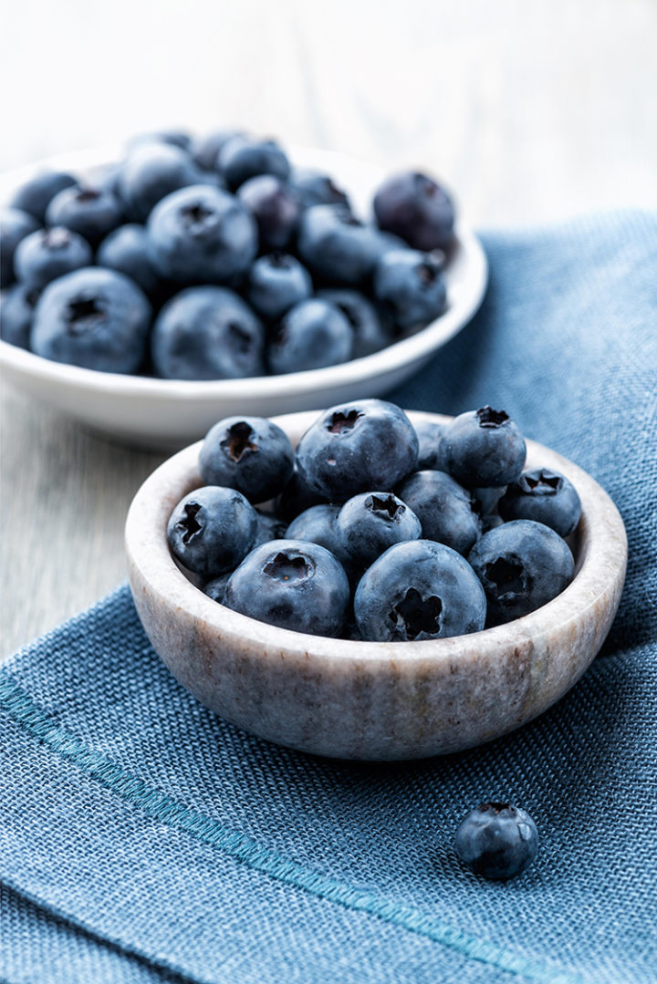 bowl of fresh blueberries on a blue napkin