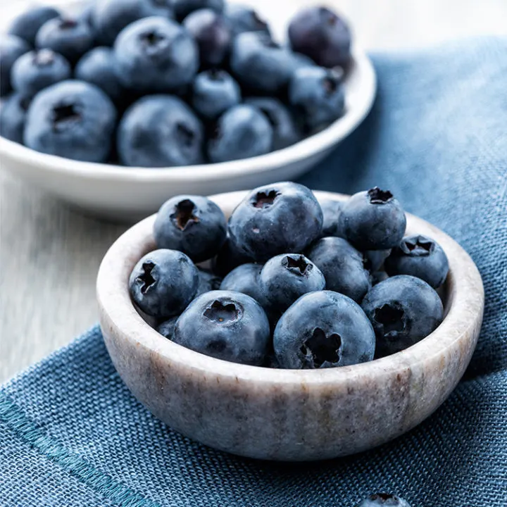bowl of fresh blueberries on a blue napkin