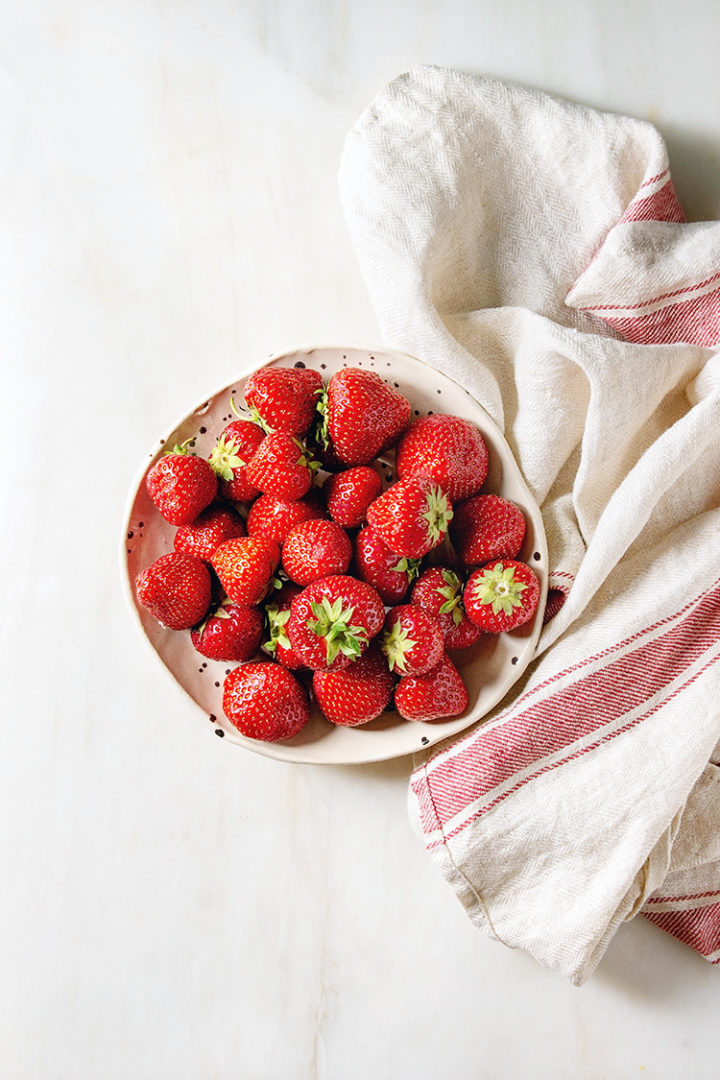 overhead shot of fresh strawberries on a plate