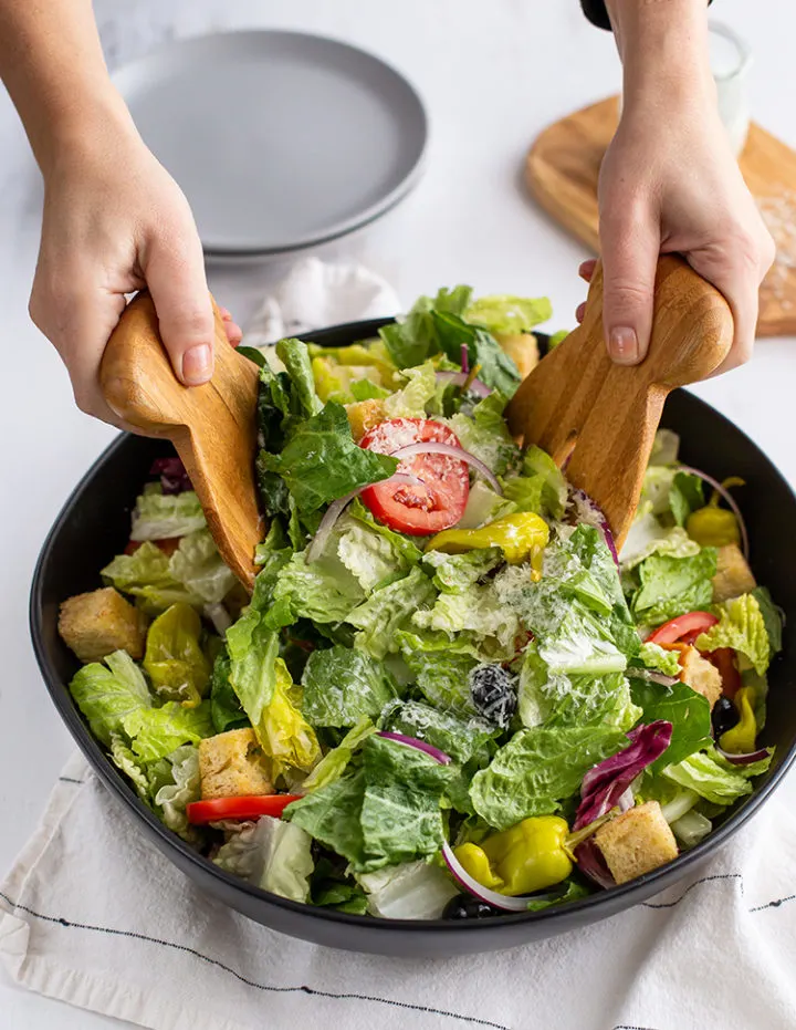photo of copycat olive garden salad in a large black salad bowl