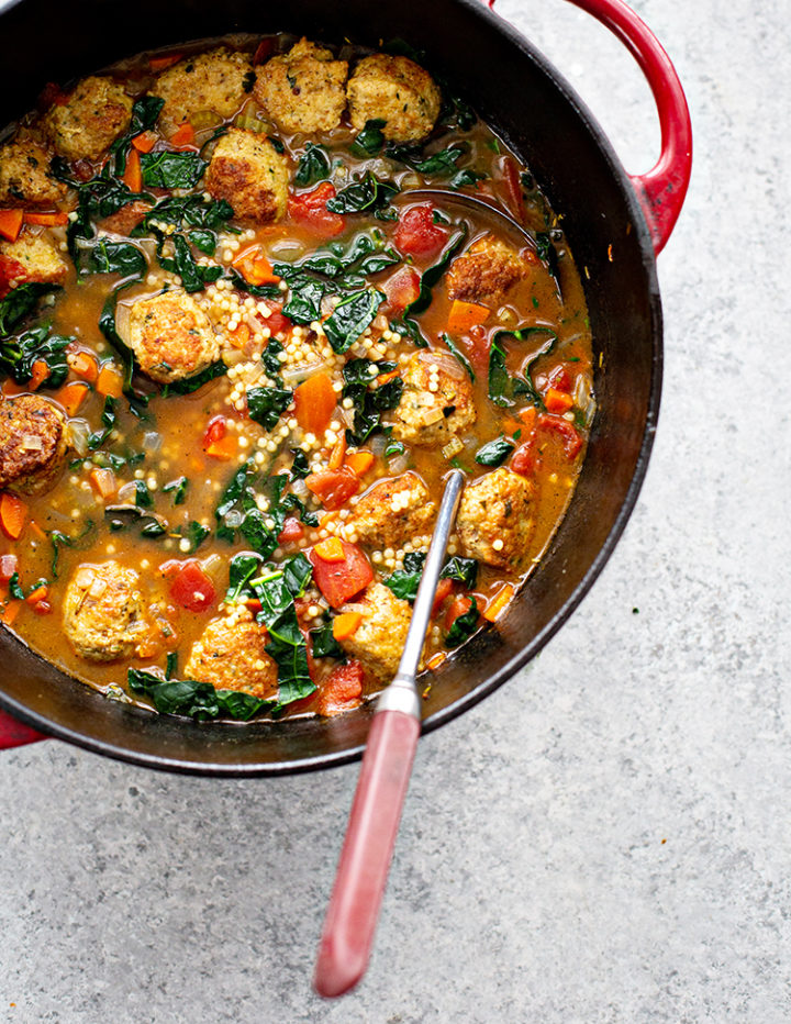 an overhead image of a large pot of italian wedding soup