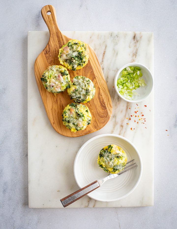 overhead shot of mini Crustless Broccoli Quiche on a cutting board