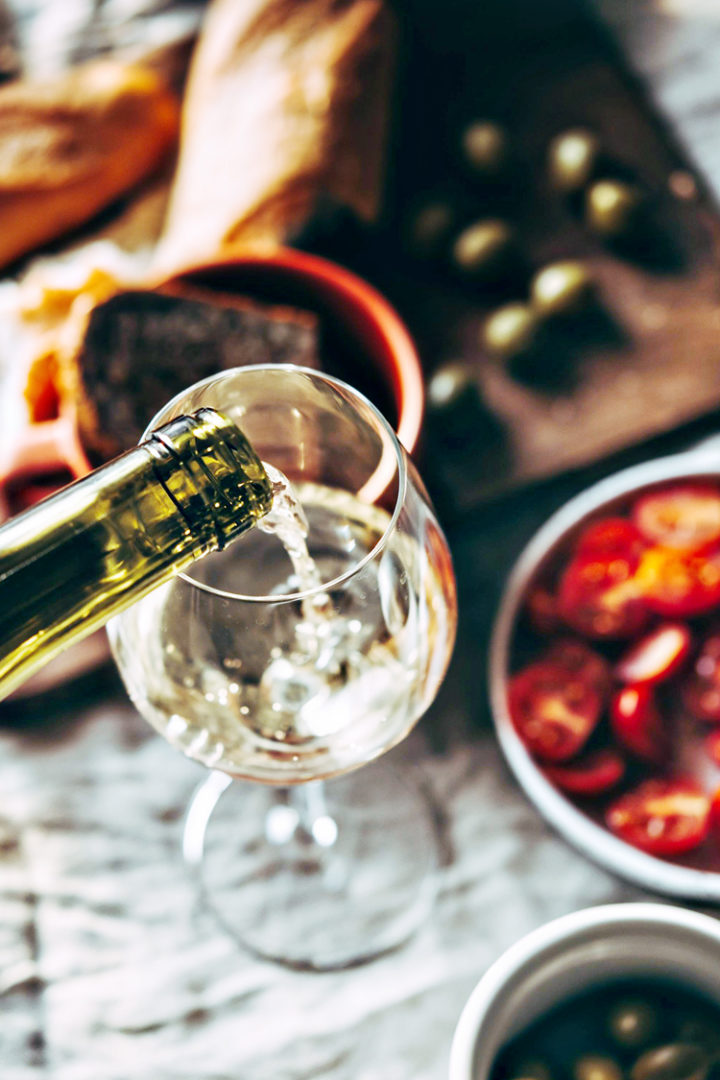 pouring a glass of wine at a meal