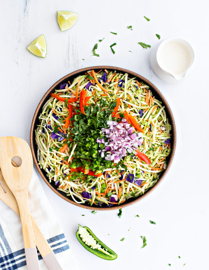 overhead photo of ingredients to make cilantro lime broccoli slaw in a bowl