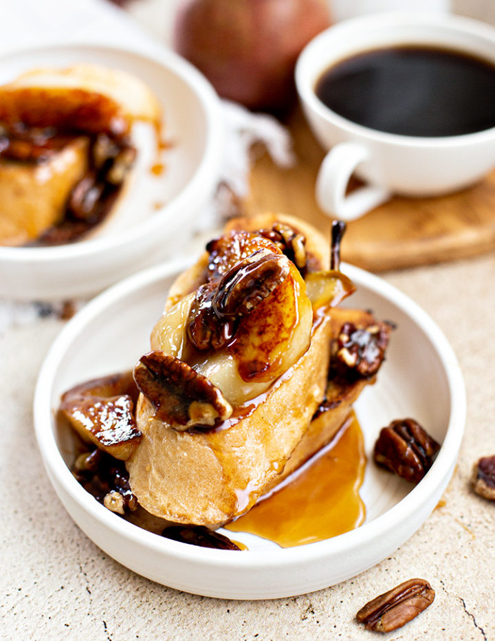 photo of pecan french toast with pears on plates for breakfast with a mug of coffee in the background