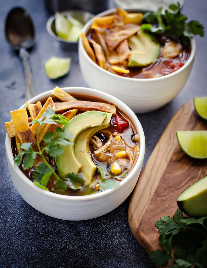 Photos of styled chicken tortilla soup in white bowls