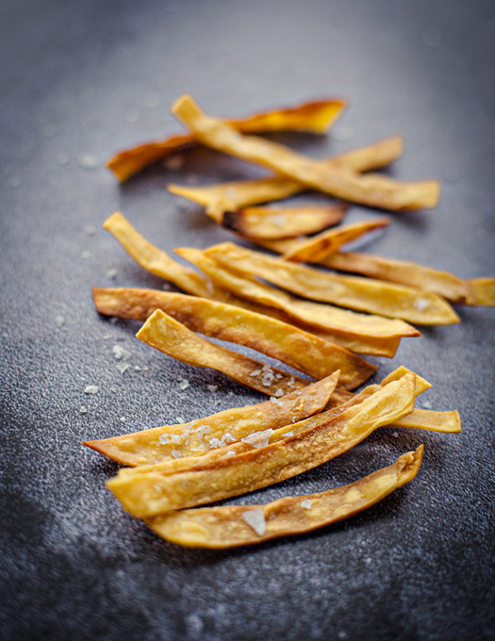 homemade crispy tortilla strips for chicken tortilla soup on a kitchen counter