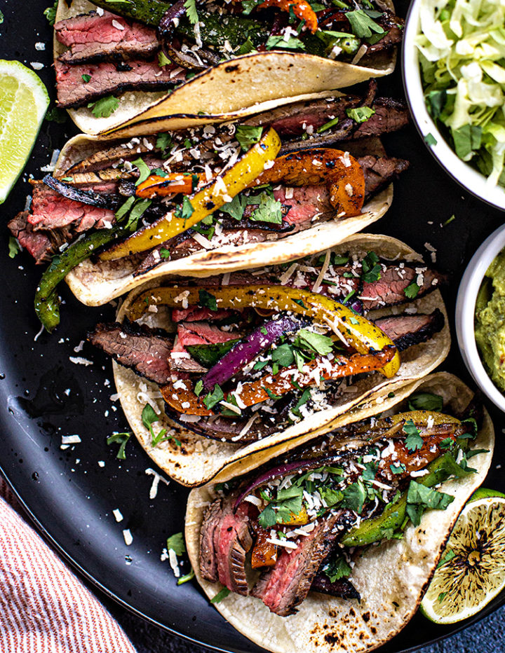 photo of a platter of flank steak fajitas 