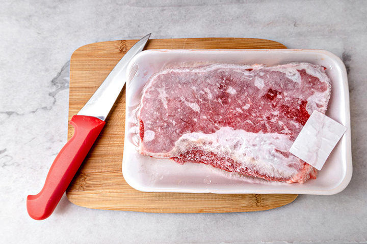 photo of meat defrosting on a cutting board