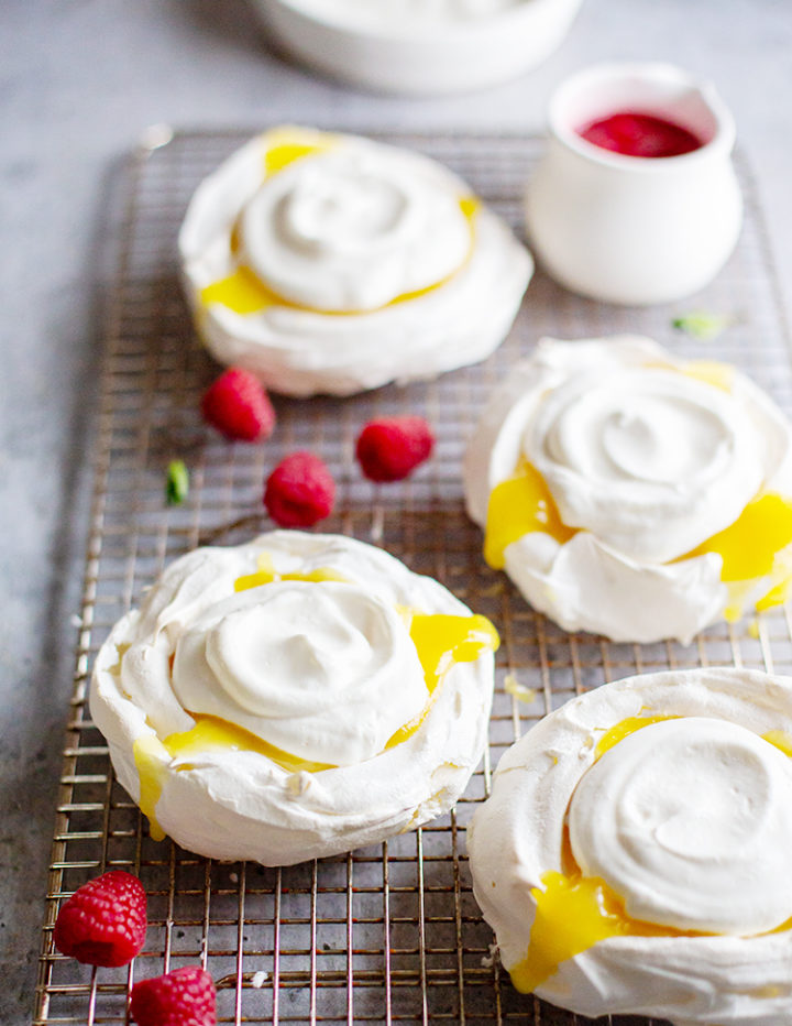 a photo of pavlova with lemon curd and whipped cream