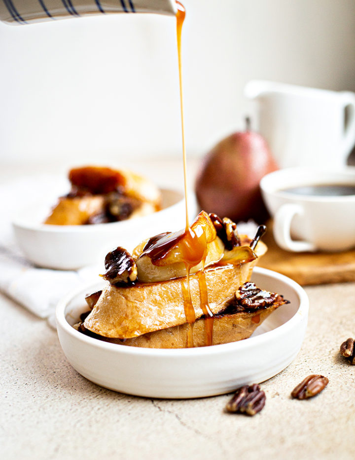 photo of maple syrup pouring on pecan french toast with pears