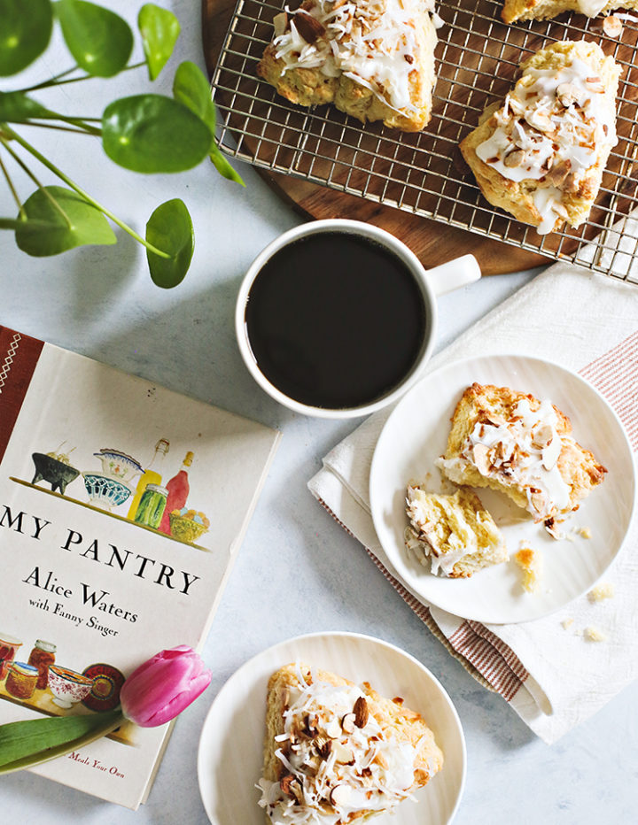 photo of toasted coconut scones on a plate with a cup of coffee