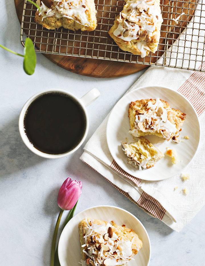 photo of toasted coconut scones on a plate with a cup of coffee