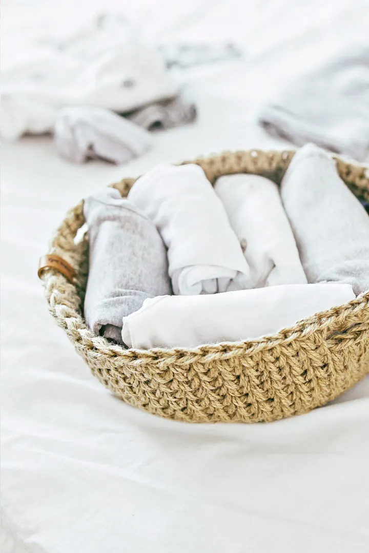a photo of a basket of white laundry
