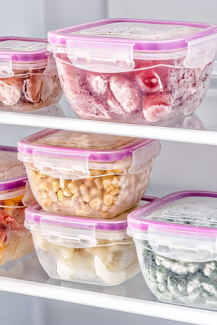 photo of frozen tomatoes in a container in the freezer