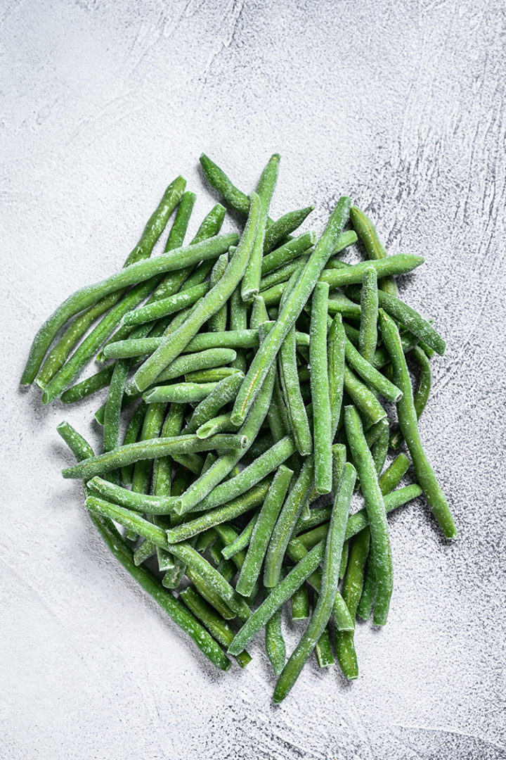 photo of frozen green beans on a white surface