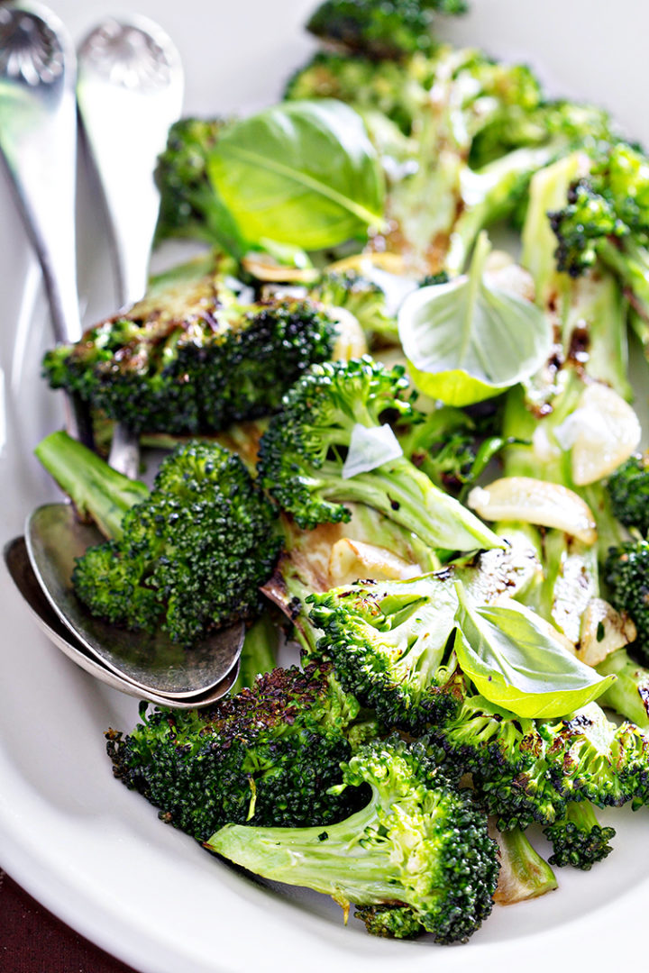 photo of roasted broccoli in a white serving dish