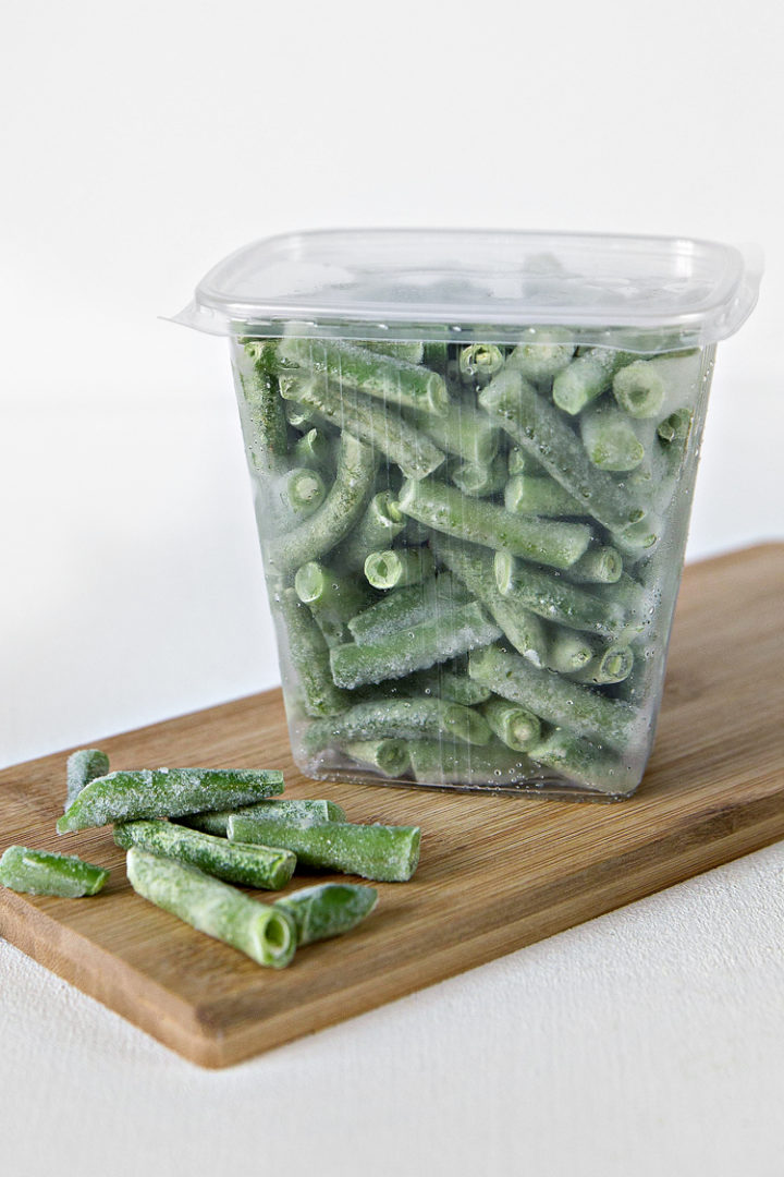 photo of frozen green beans in a storage container