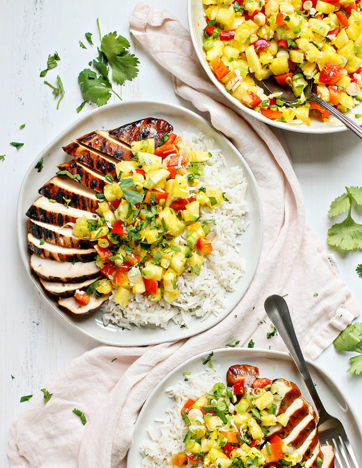 an overhead photo of a plate of coconut rice with pineapple salsa chicken