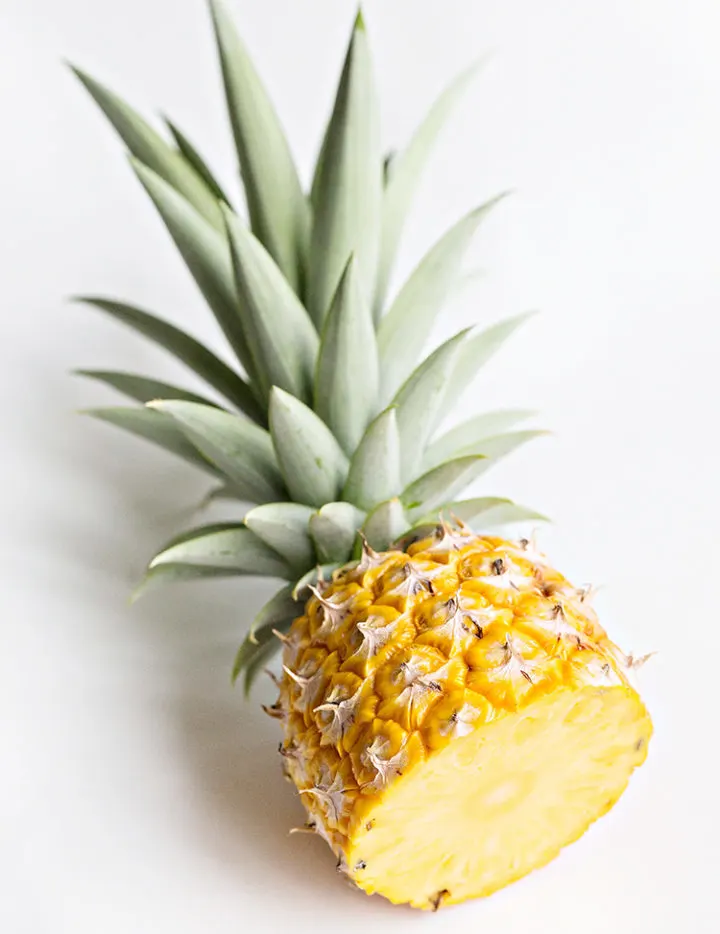 photo of fresh pineapple cut in half for a recipe for pineapple juice with mint