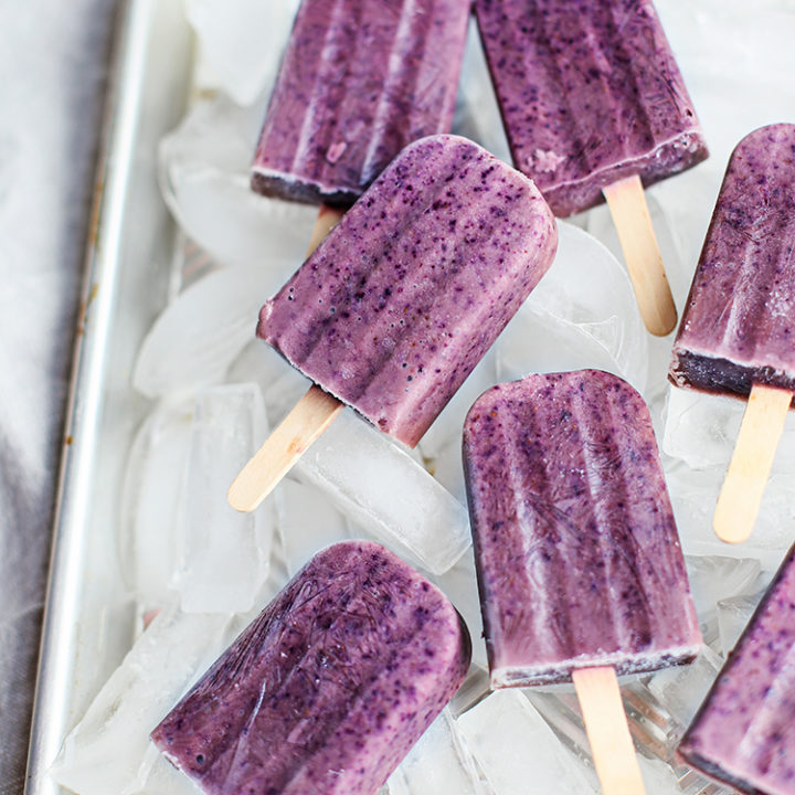 blueberry popsicles in a tray with ice