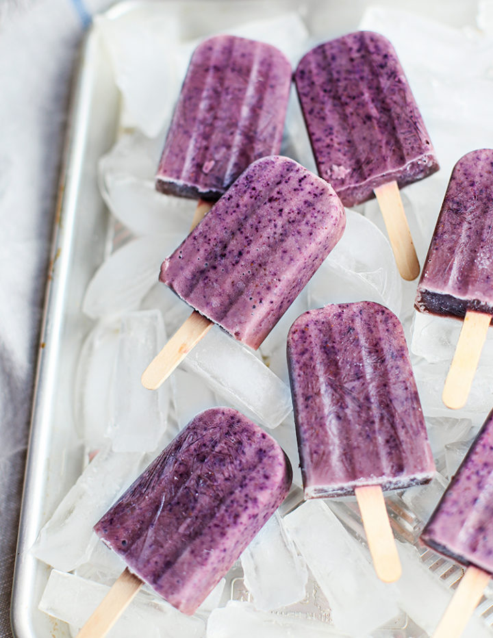 blueberry popsicles on a tray with ice