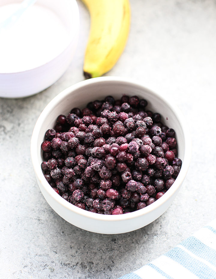 blueberries, yogurt, and banana on a counter